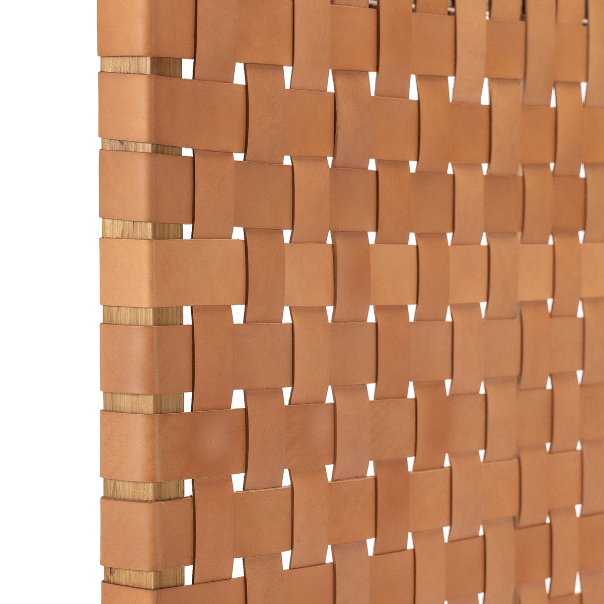 Close-up shot of the leather straps on a Scandinavian headboard detailing the fine weaving technique.