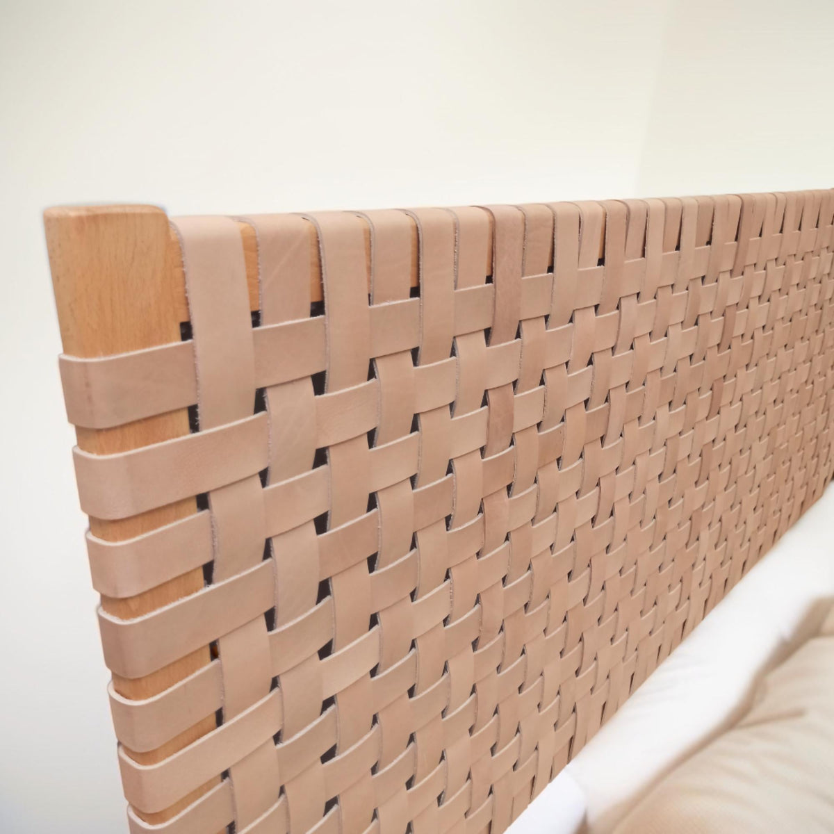 Side profile of a contemporary strap woven leather headboard highlighting its dynamic structure queen size headboard.