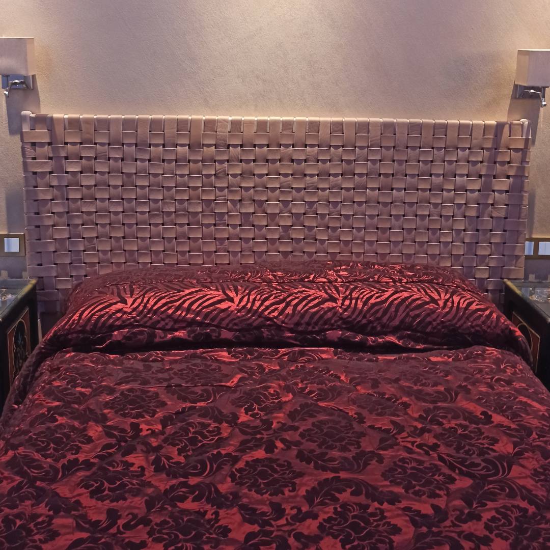 Handcrafted woven strap leather headboard, full view showcasing artisanal design and premium natural leather details.