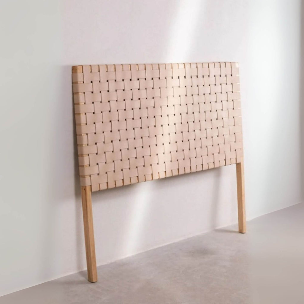 Leather headboard shown with neutral bedding and soft lighting