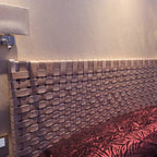 Side angle view of a modern rustic woven strap leather headboard, emphasizing clean lines and premium craftsmanship.