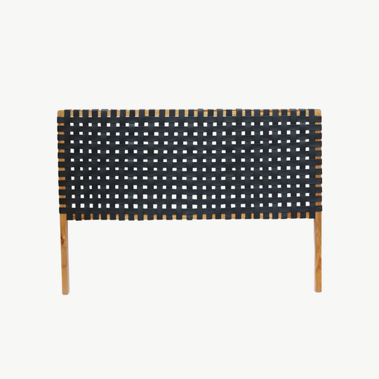 Detailed focus on the texture of the leather straps in a classic woven headboard