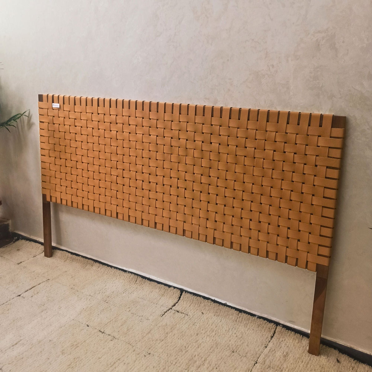 walnut wooden headboard against a plain wall