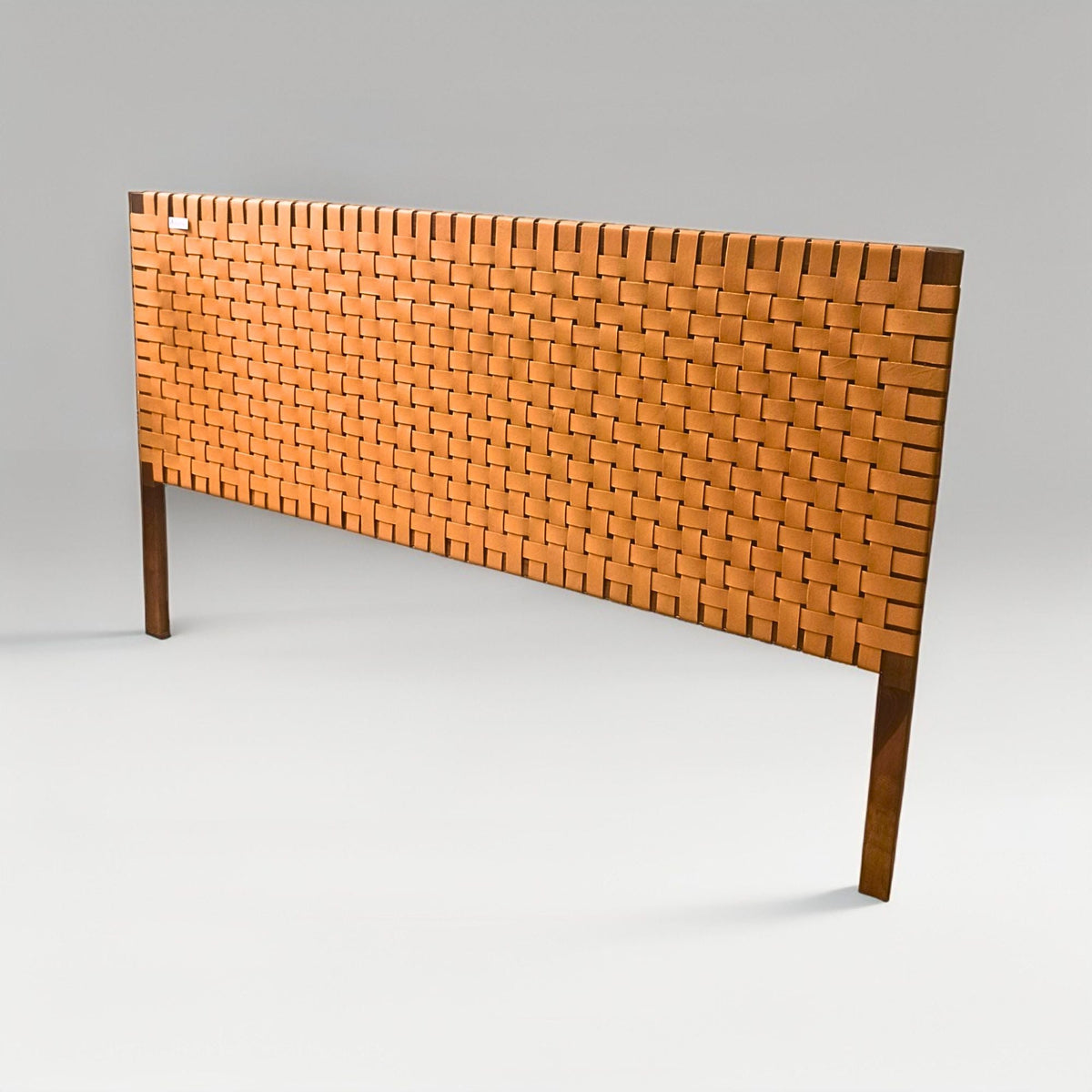Woven leather headboard on a gray background